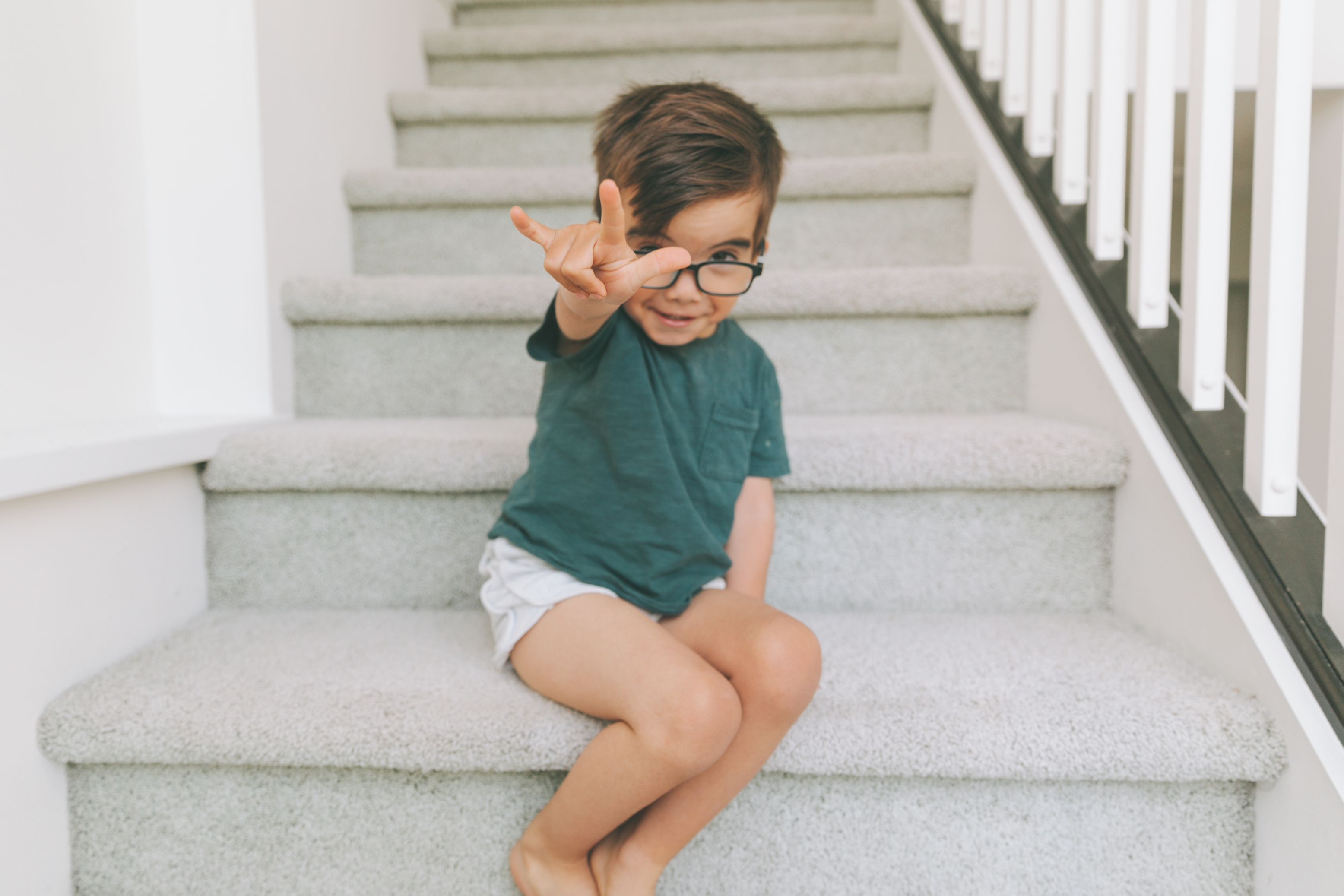 Little Boy Using Sign Language on the Stairs